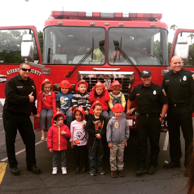 A photo of Hiatt and his pre-school class with firemen